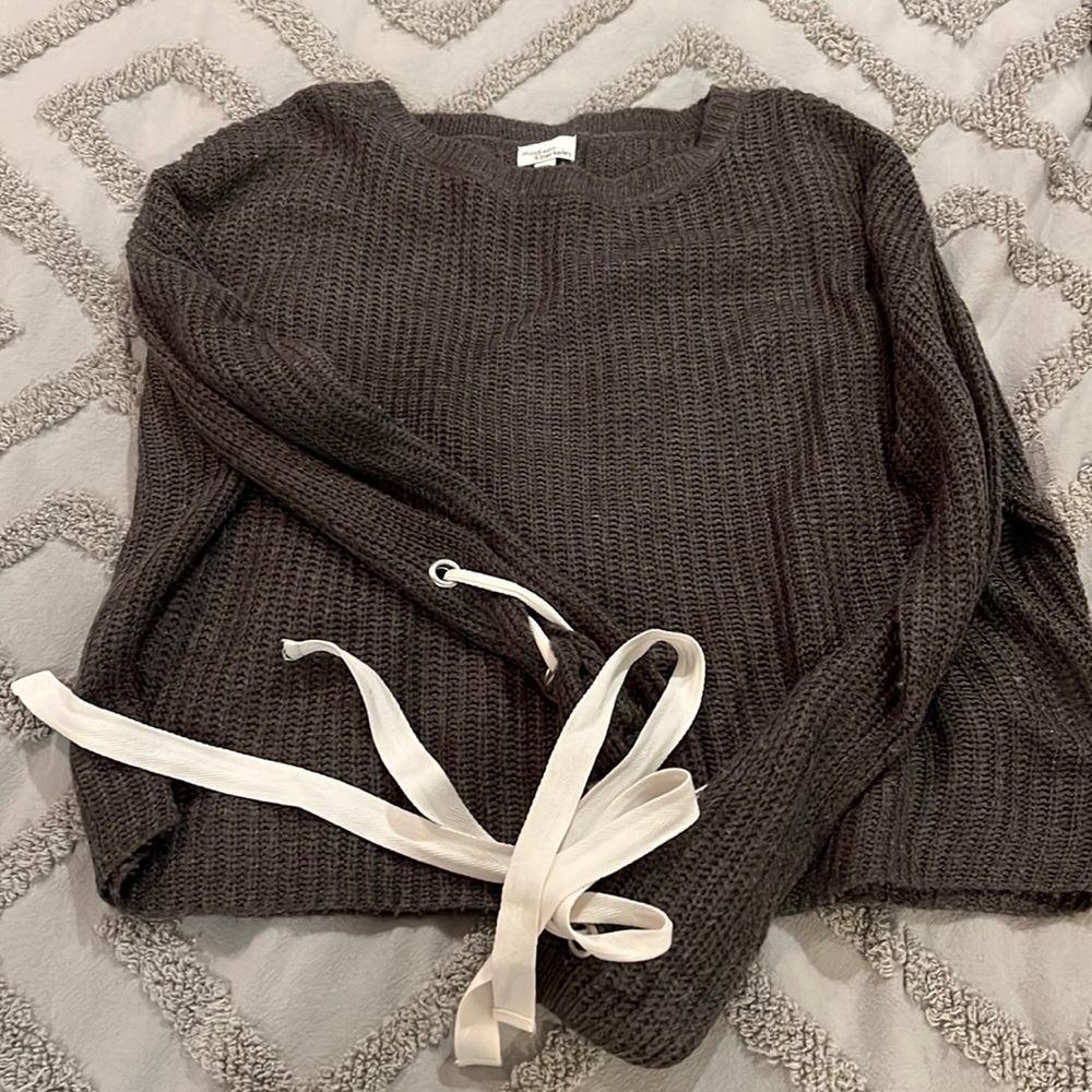 Gray sweater with ties on the sleeves